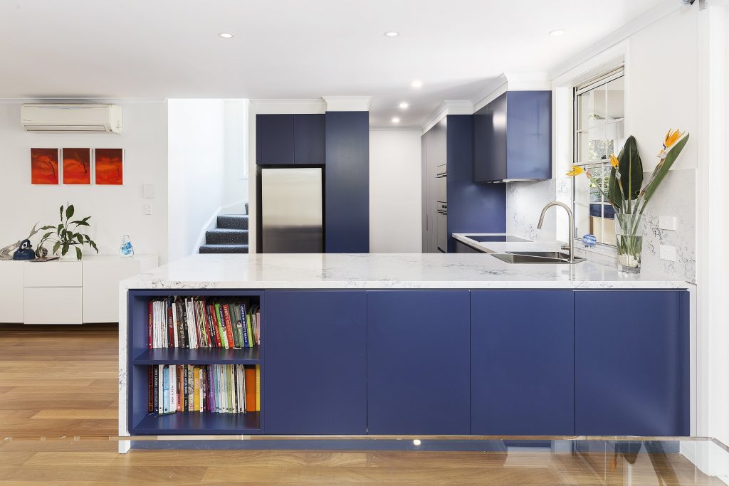 Rozelle, Polyurethane Kitchen with a 40mm stone benchtop and splashback, featuring a pocket display shelf in the breakfast bar